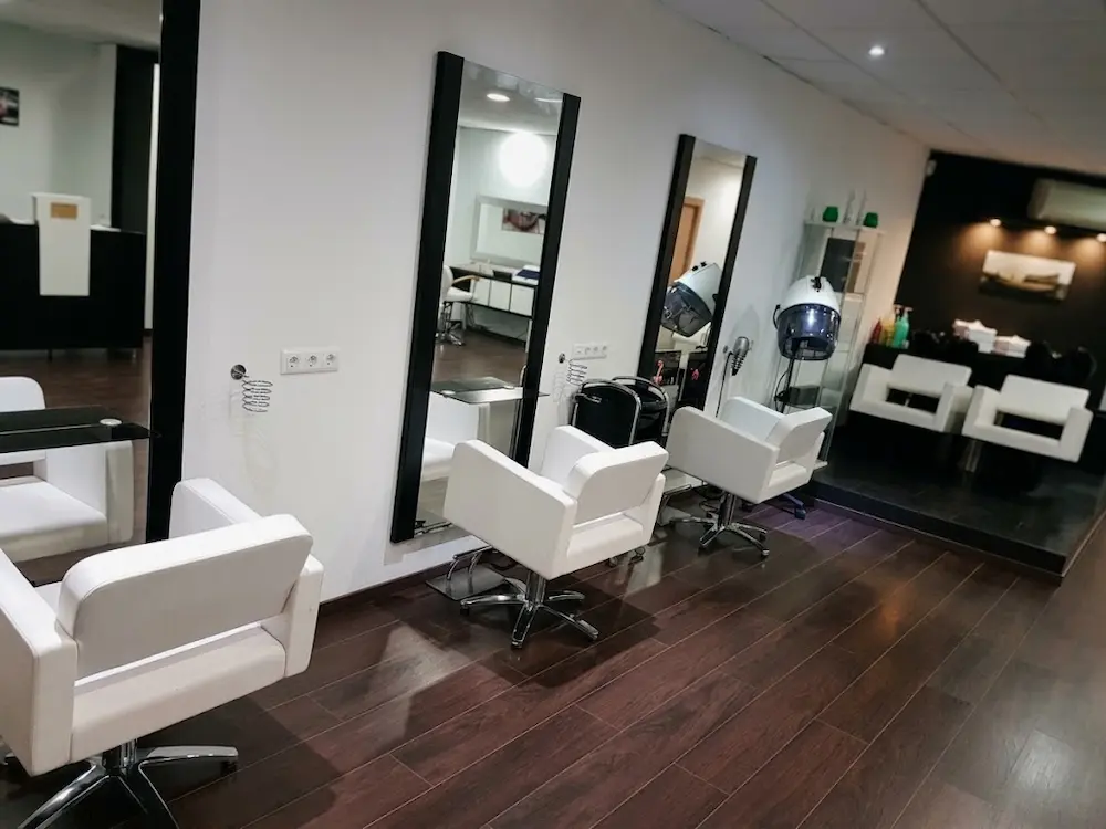 Interior del salón Modern Cut con sillones y espejos de peluquería